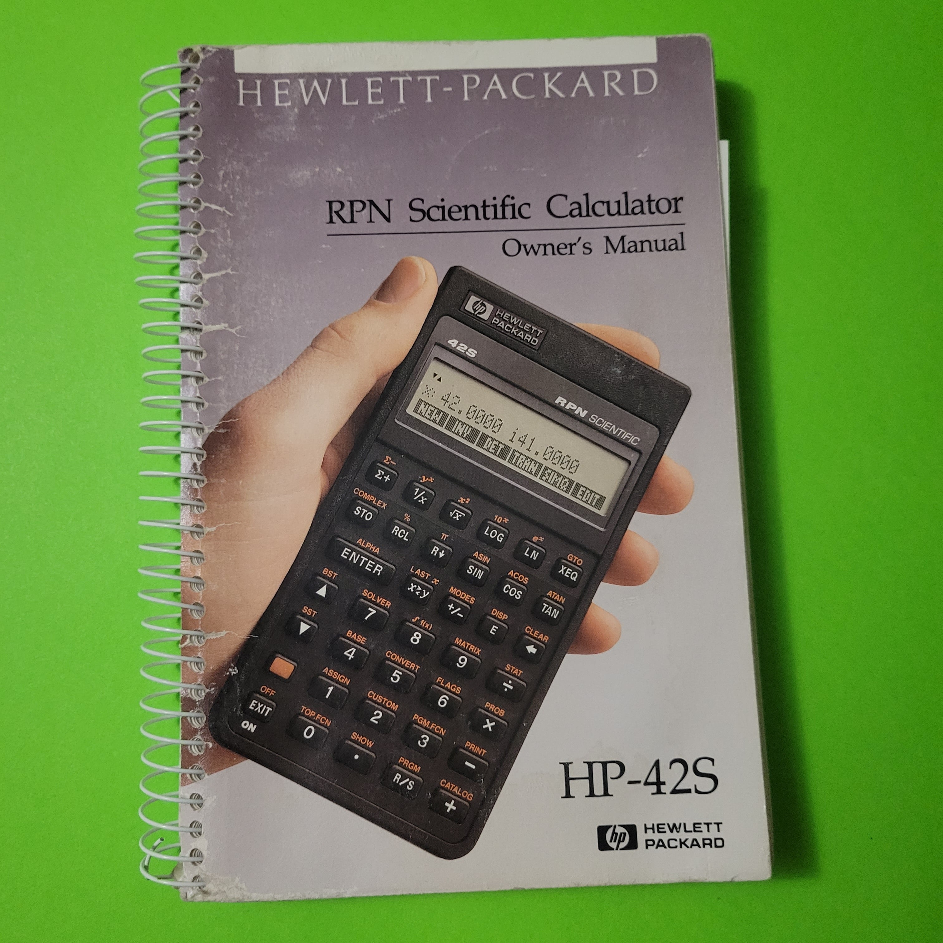An image of the front of the manual of a HP 42s RPN Scientific Calculator